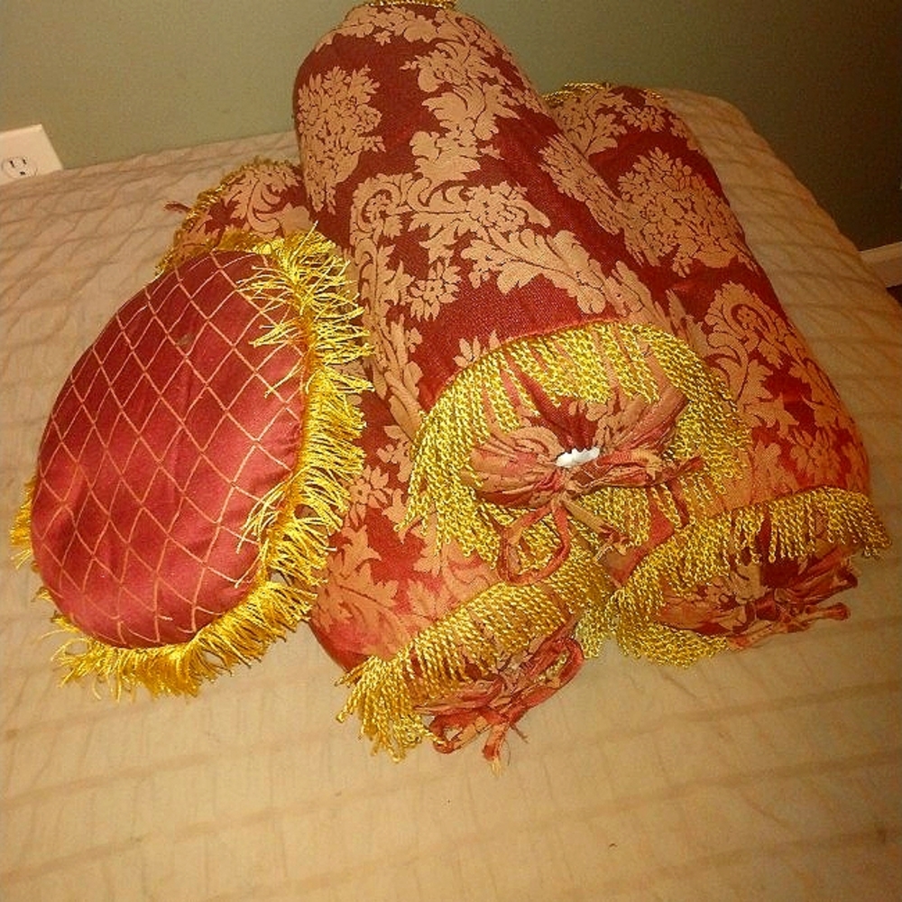 Fancy red and gold throw pillows with tassels